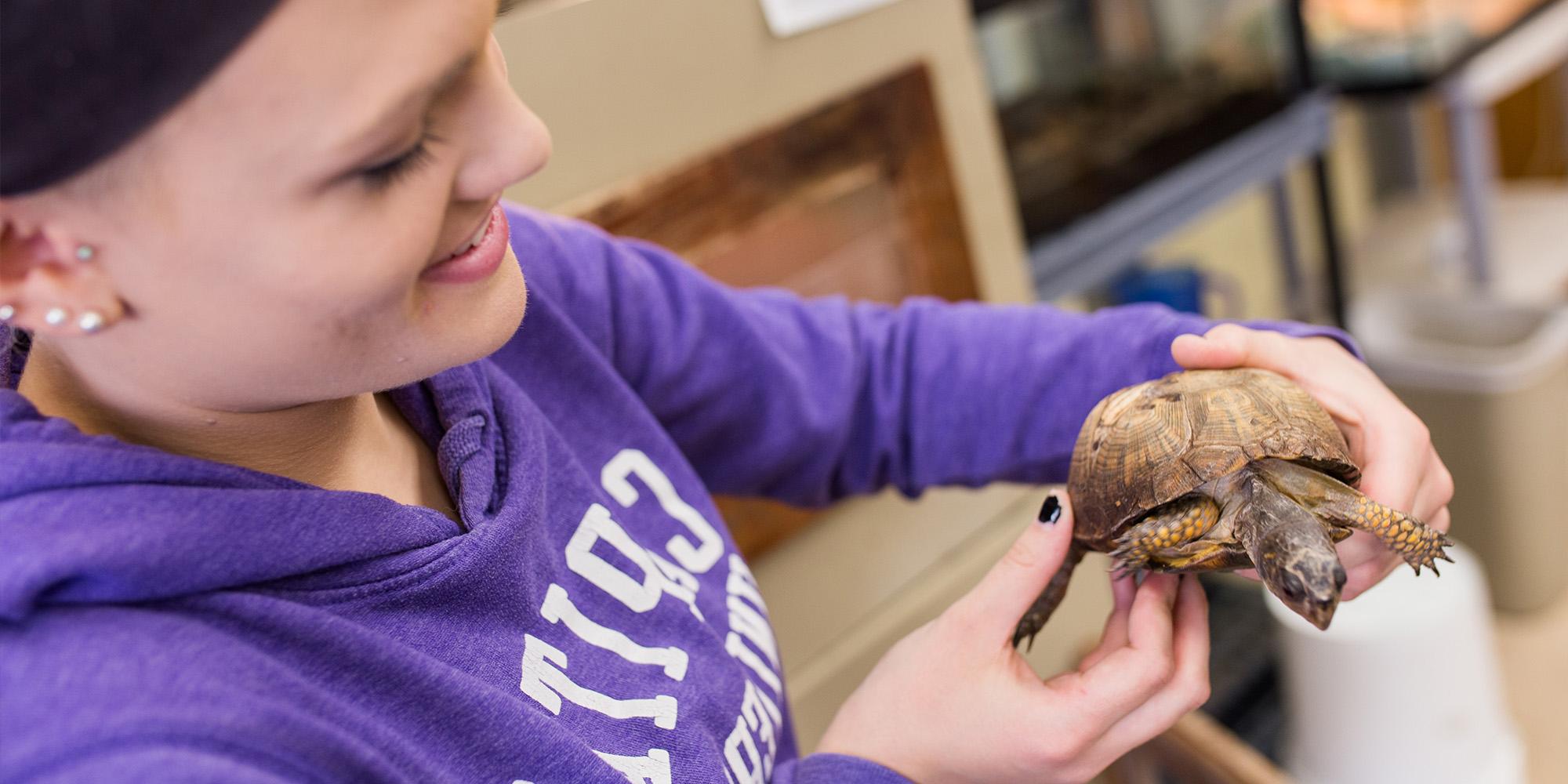 Female Student Holding A Turtle